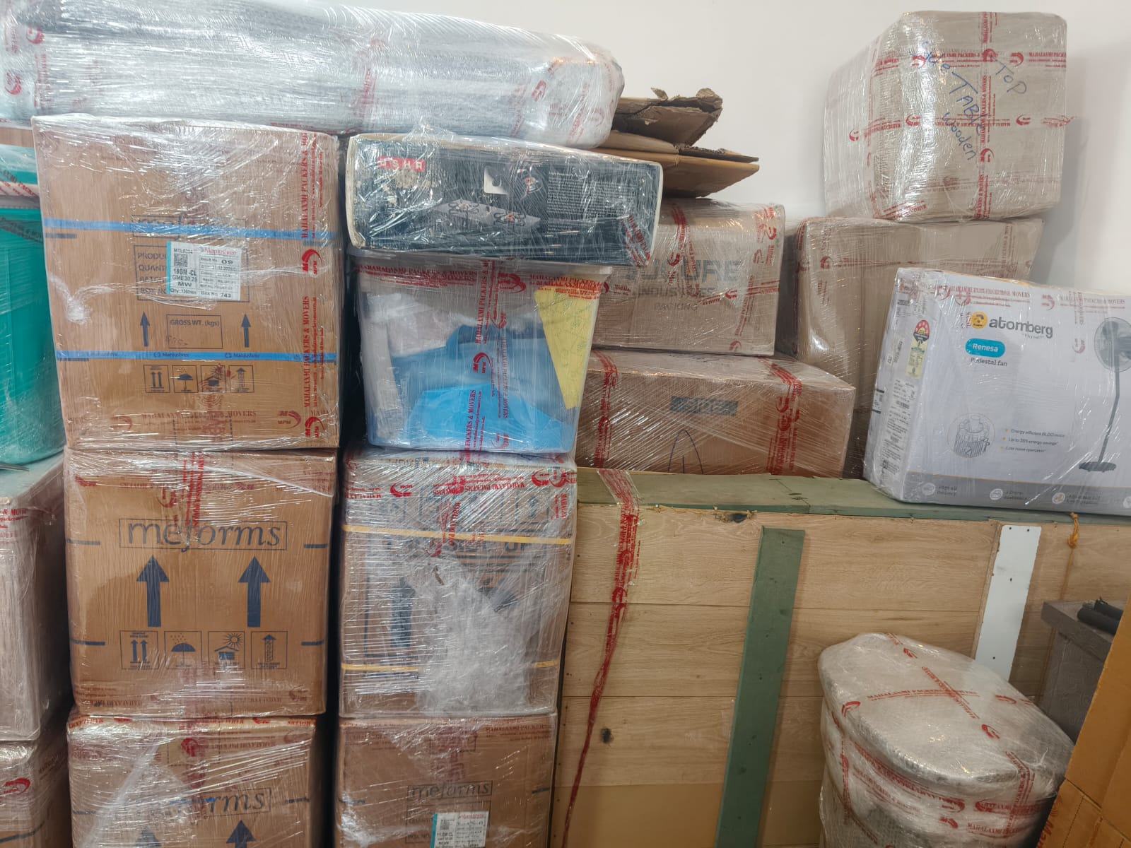 Packed household cartons and appliances prepared for moving