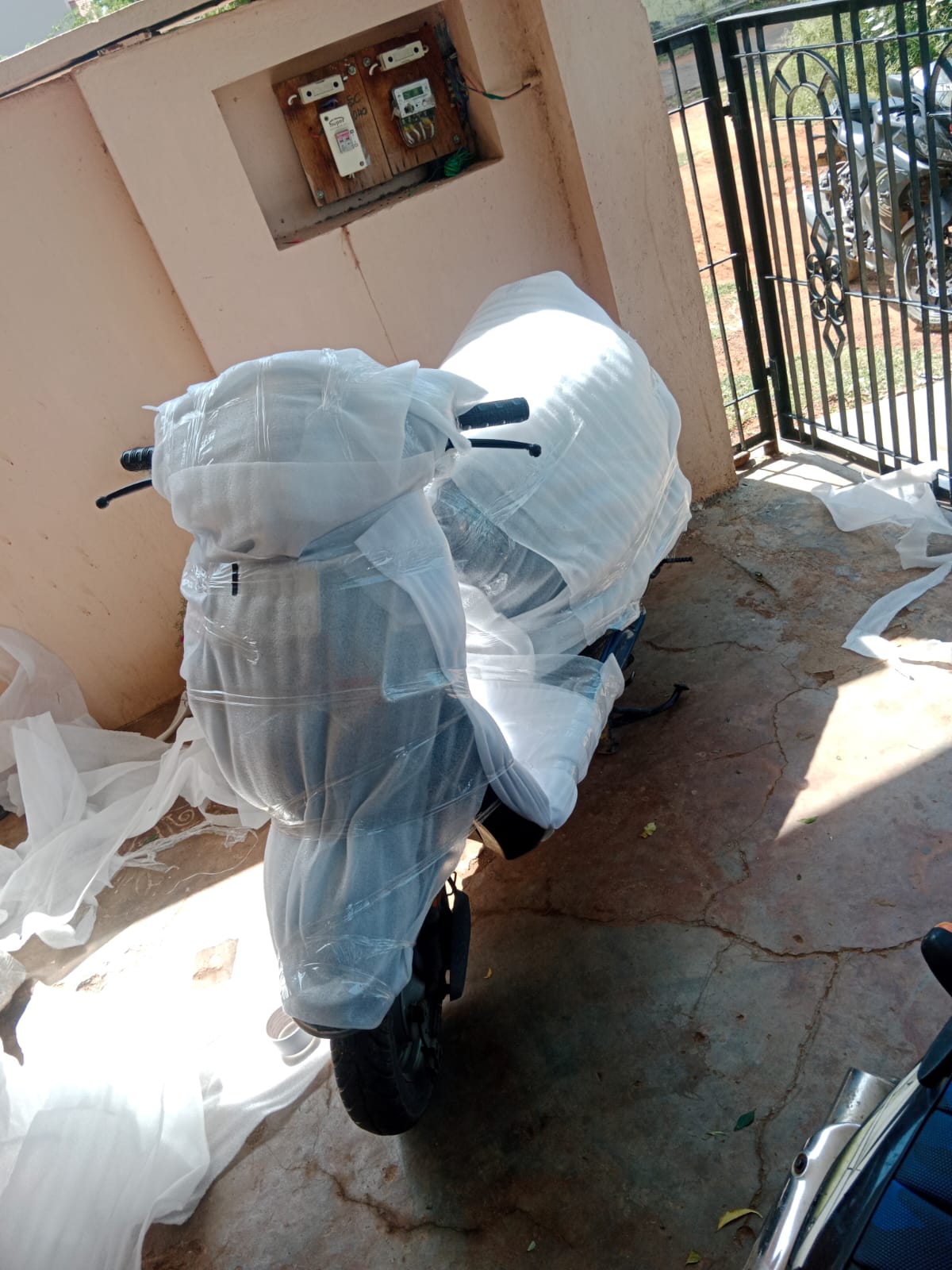 Two wheeler wrapped with protective material for bike transport