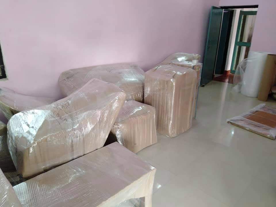 Wrapped household furniture inside a room ready for relocation